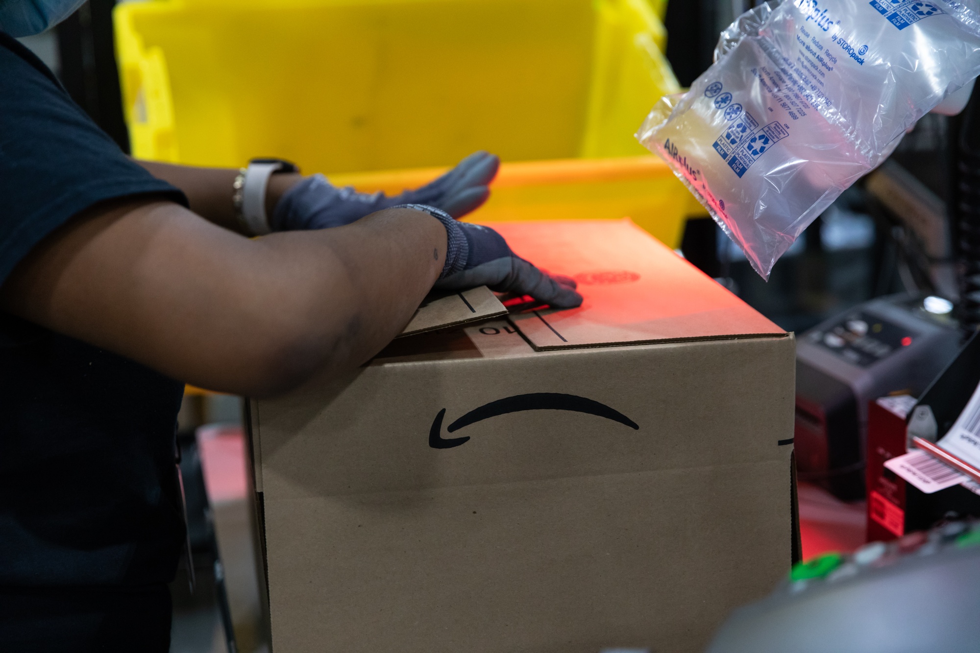 A worker assembles a box at an Amazon fulfillment center in Raleigh, North Carolina.