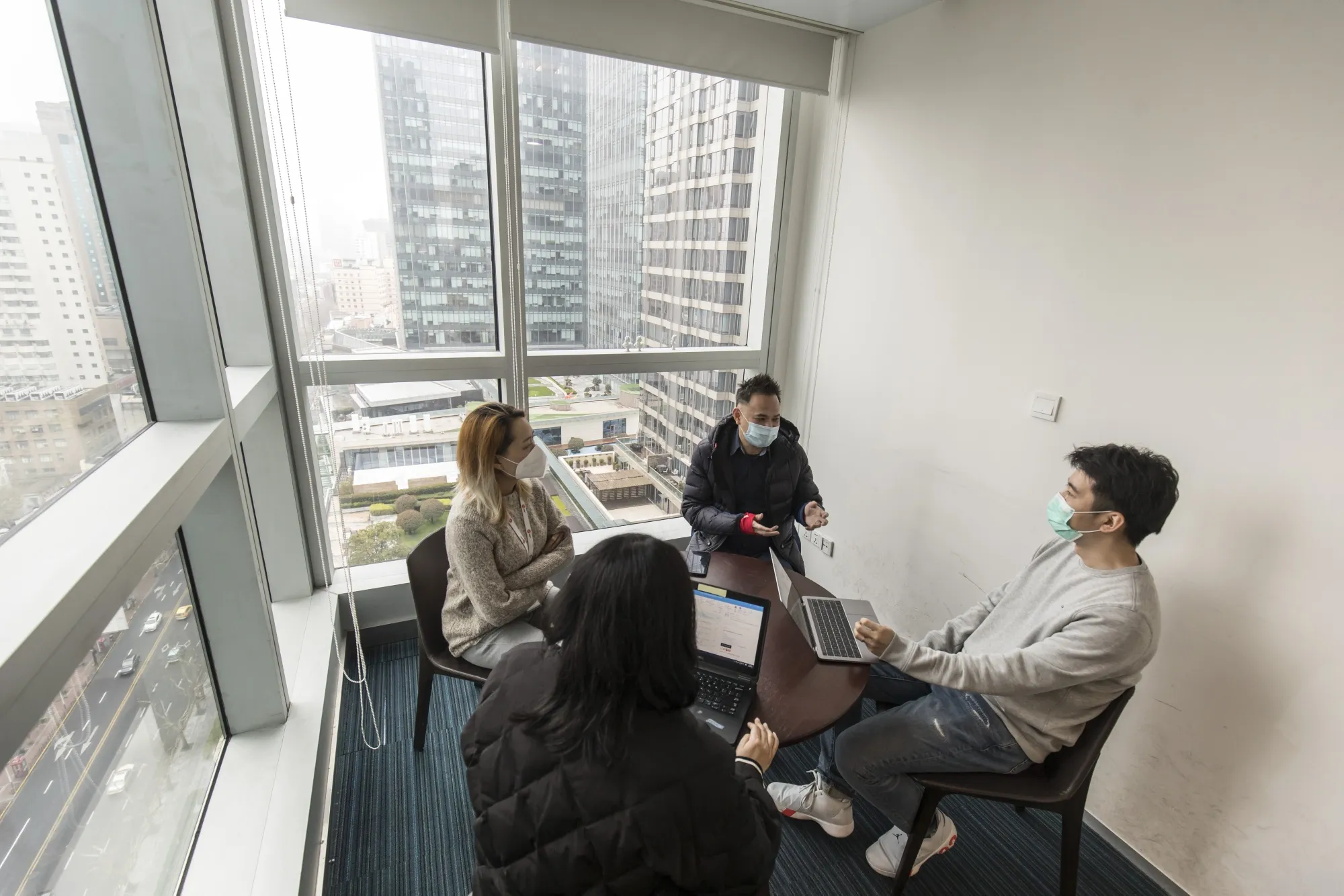 Alvin Foo, managing director of Reprise Digital, center, during a meeting with staff&nbsp;at the company’s office in Shanghai on March 9.