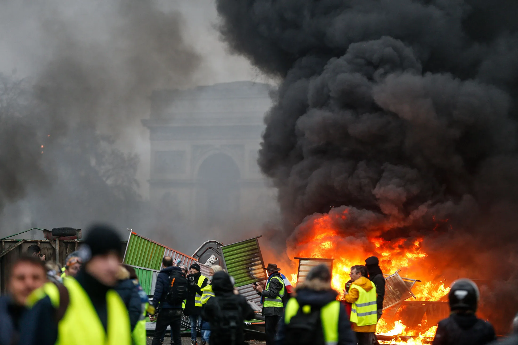 Demonstrators stand next to a fire during protests in Paris on Dec. 1.