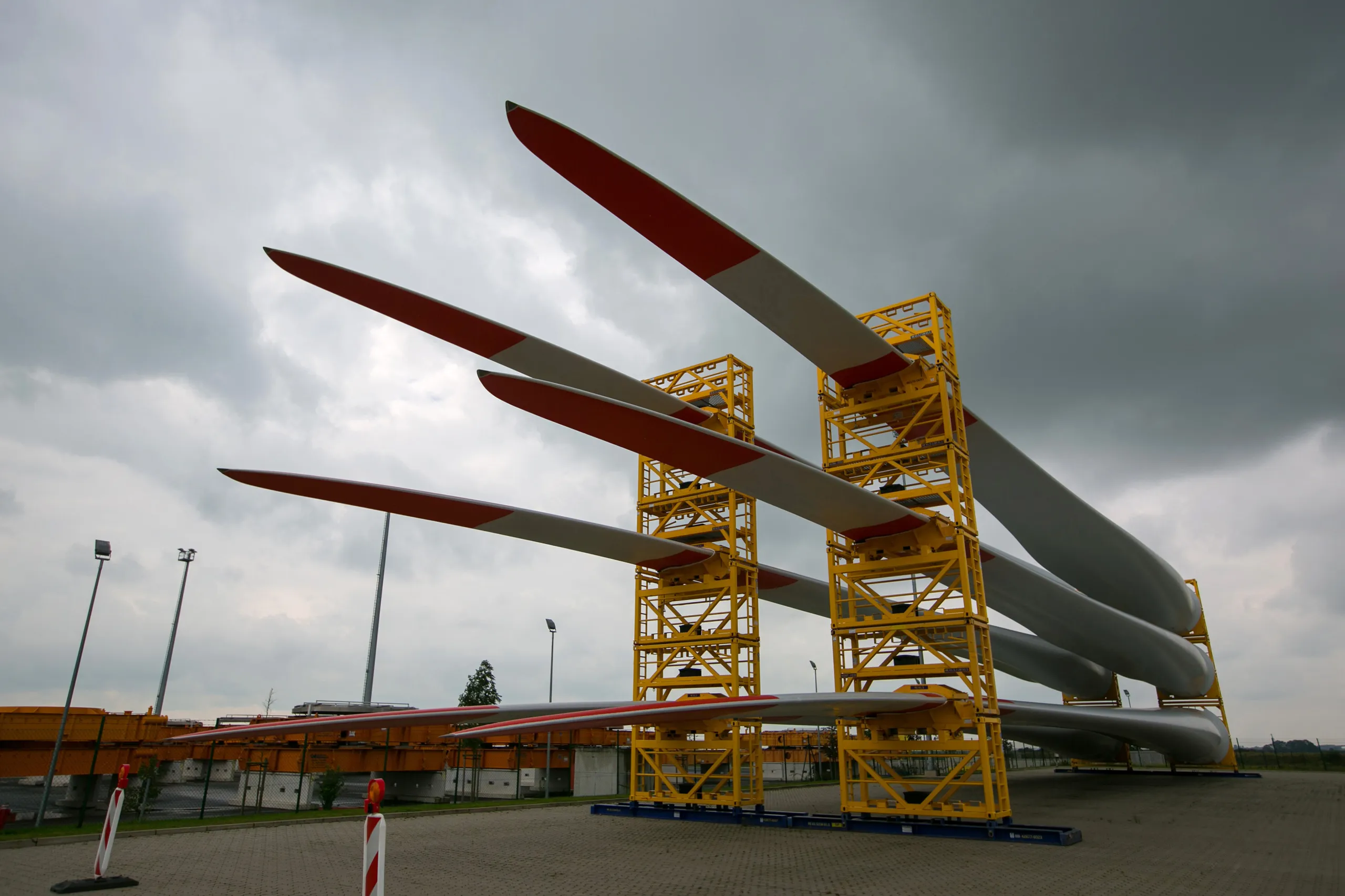 Wind turbine blades sit in support frames in Bremerhaven, Germany.