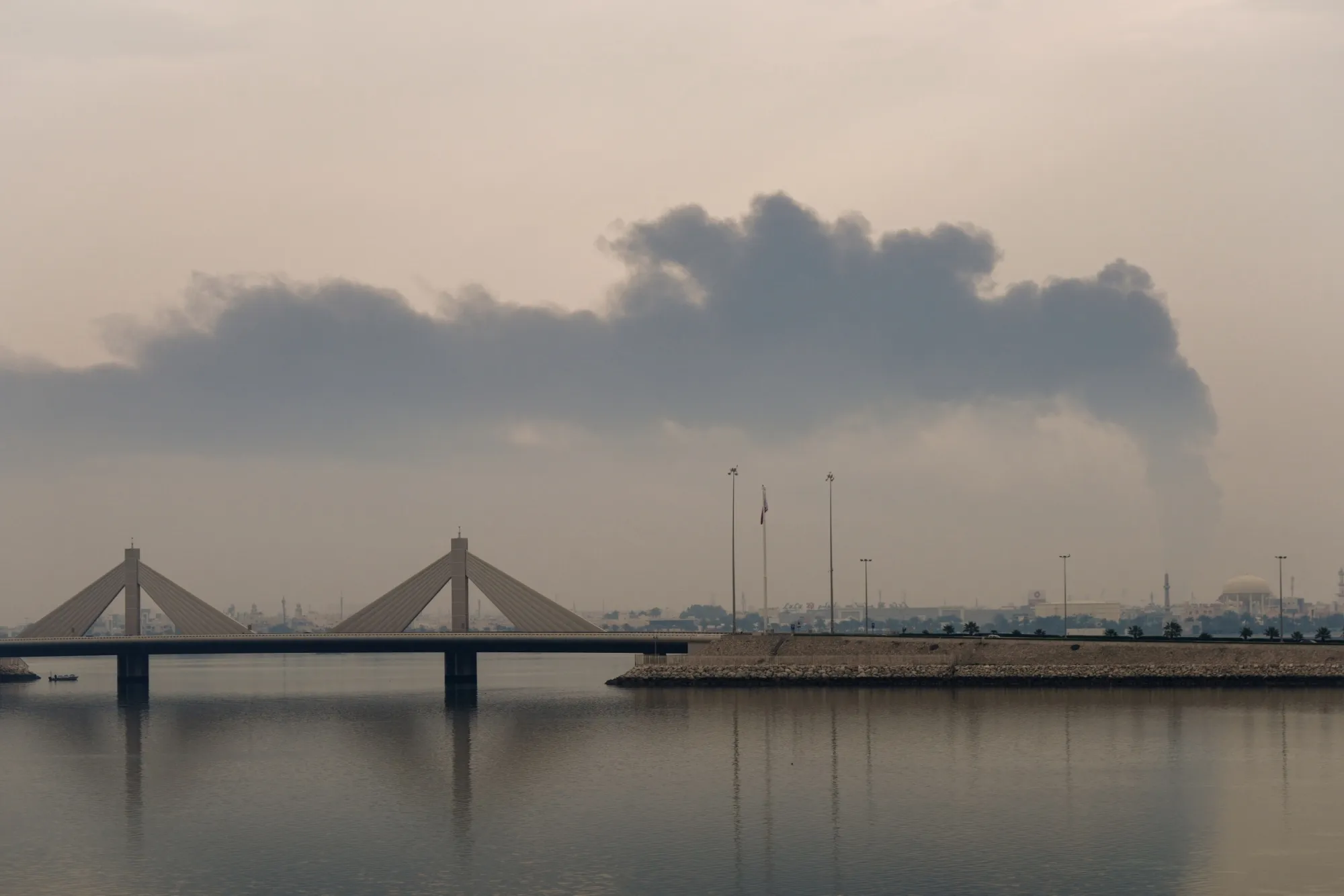 A plume of smoke rises after a reported Iranian strike on fuel tanks in Muharraq, Bahrain, on March 12.