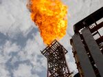 A flare rises from a Total SA floating production and storage offloading vessel, off the coast of Angola.