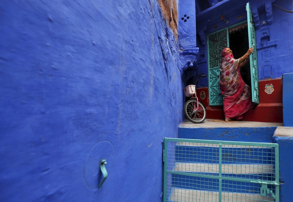 A woman on the doorstep of her house in India's &quot;Blue City.&quot;