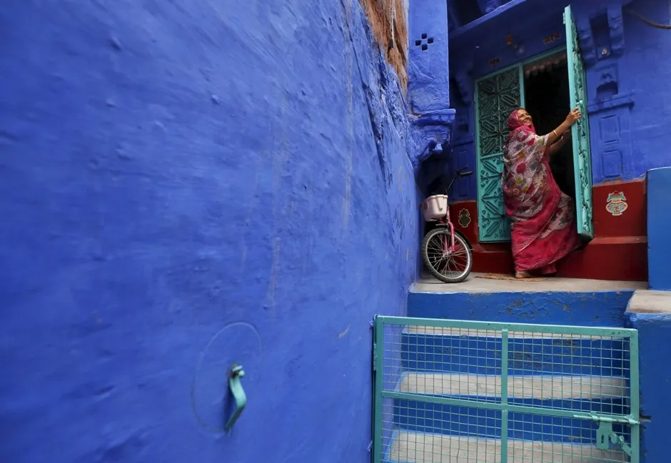 A woman on the doorstep of her house in India's "Blue City."