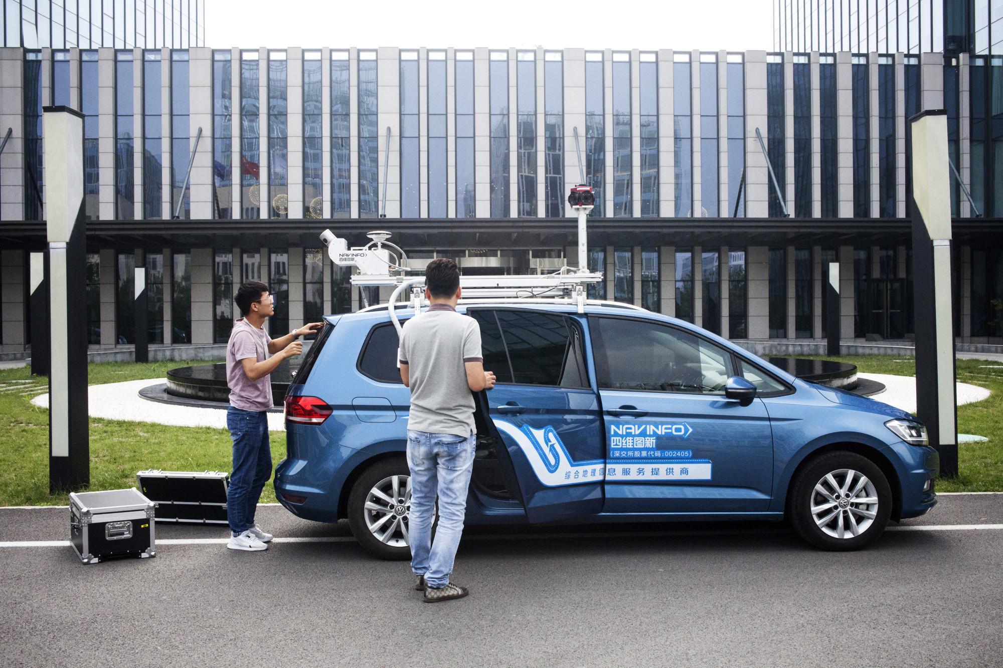 Employees prepare a NavInfo vehicle for data collection in Beijing&nbsp;on&nbsp;June 11.