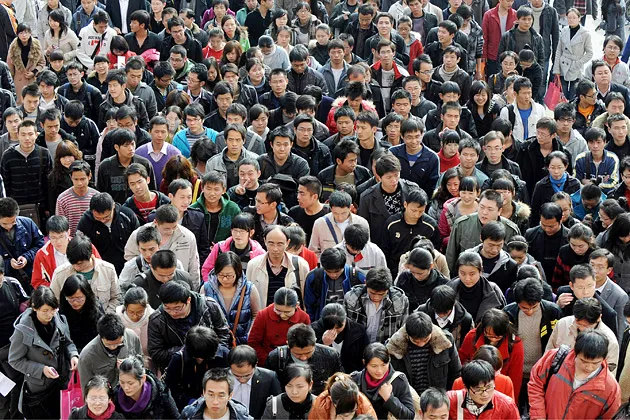 Chinese wait outside an exam site before the annual civil service exam in Hefei, Anhui province, in 2010