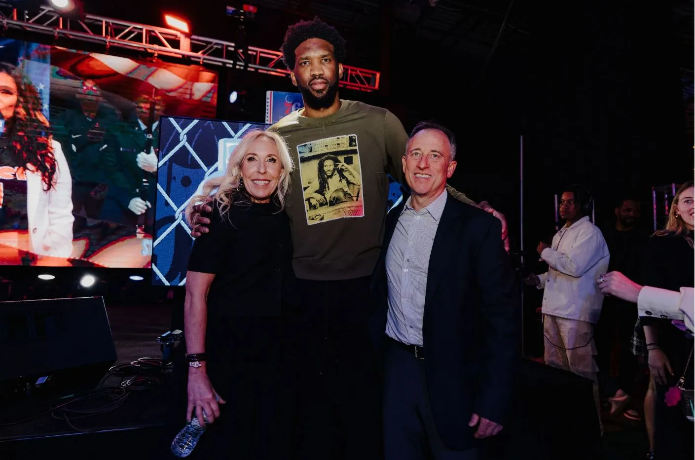 Joel Embiid, center, with Marjorie and Josh Harris