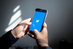 The Twitter Inc. logo is displayed on an Apple Inc. iPhone.
