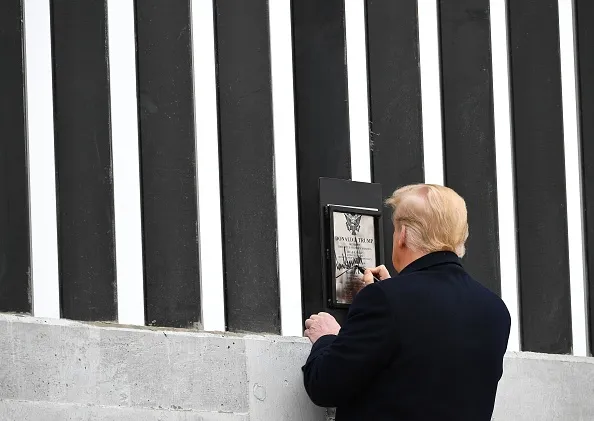 He didn’t build the wall but he left a plaque with his name on it.