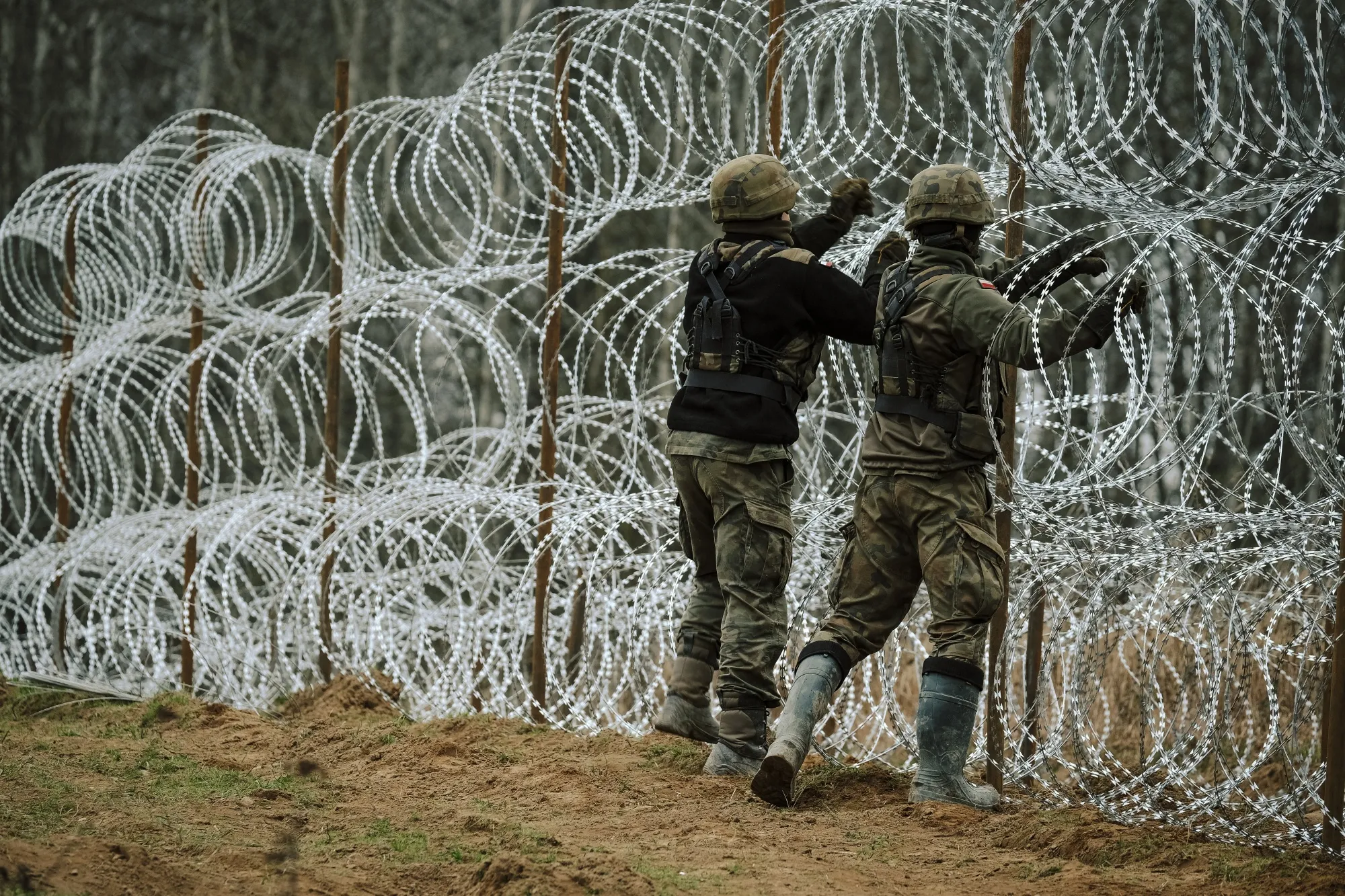 Polish soldiers construct a razor wire fence along the border with Russia’s Kaliningrad. in Zerdziny, Poland.