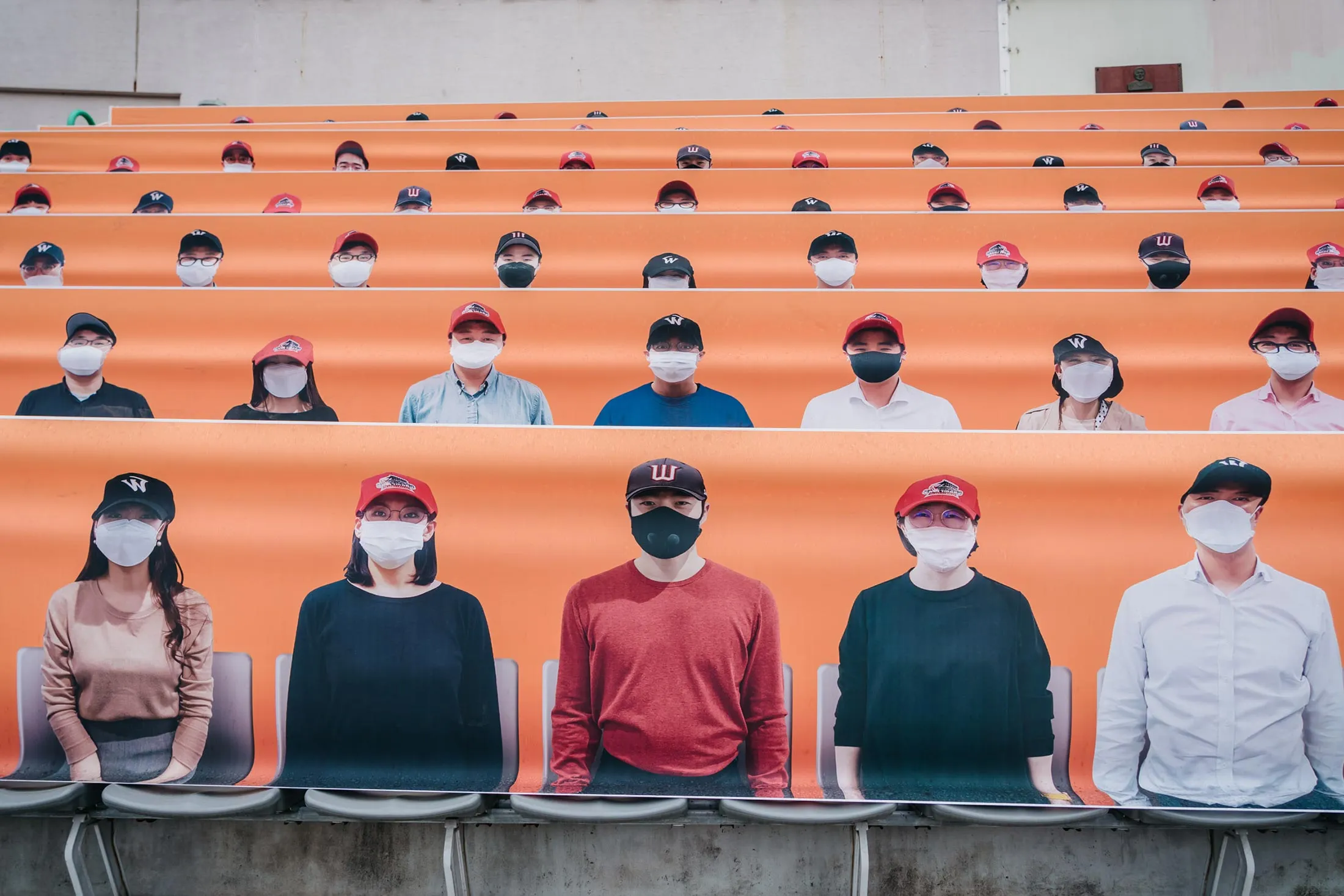 Images of fans wearing masks decorated the stadium’s outfield for&nbsp;the big-league baseball season opener in Incheon, South Korea.