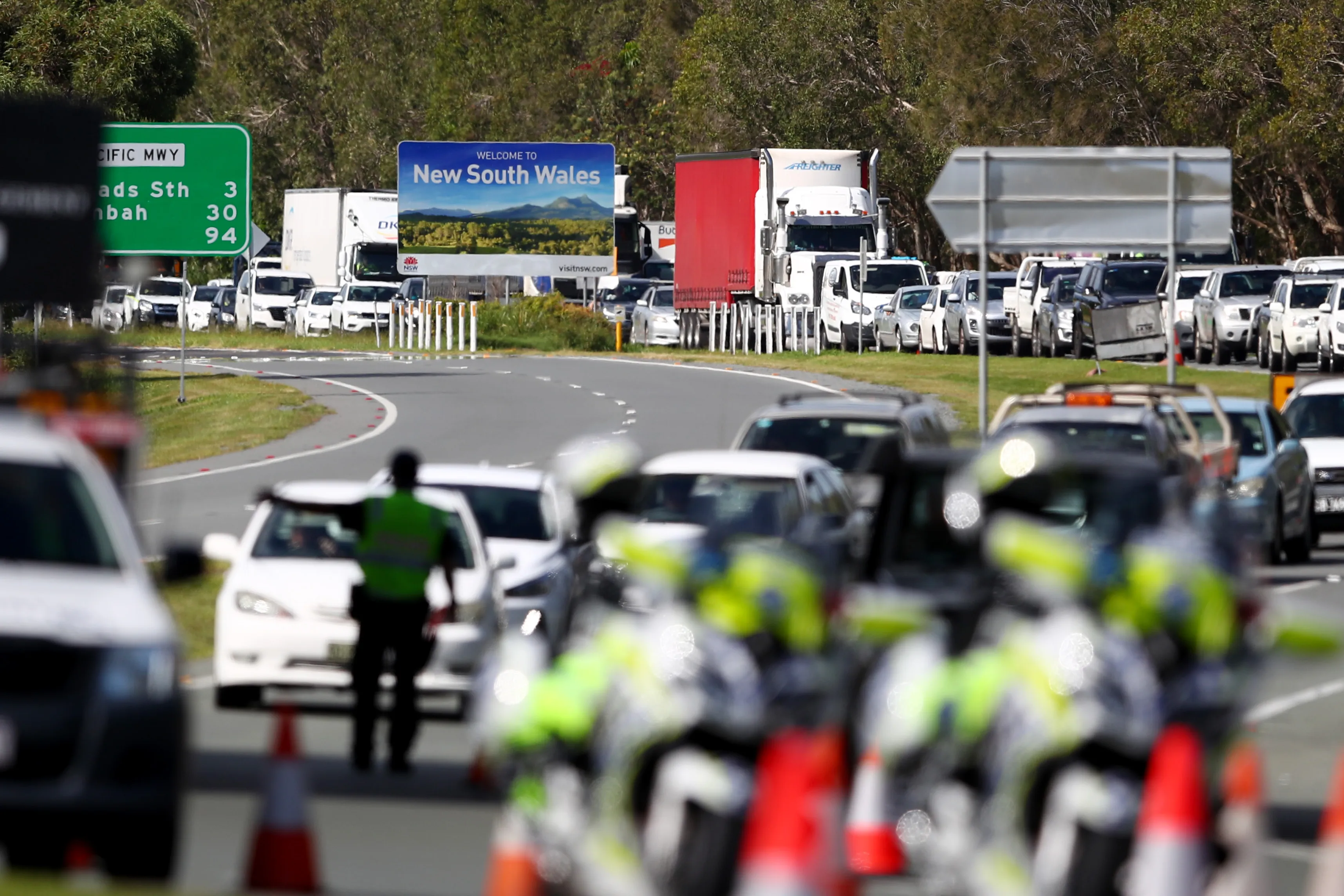 Queensland Police stop vehicles at a checkpoint set up at the Queensland and New South Wales border in Coolangatta, Australia, on March 26.