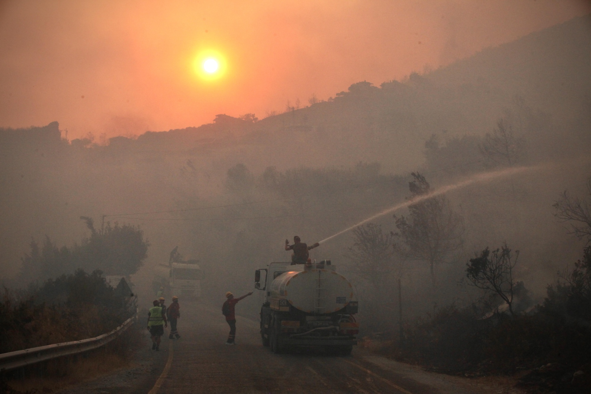 Residents help fire crews in the holiday region of Mugla on Aug. 3, 2021.