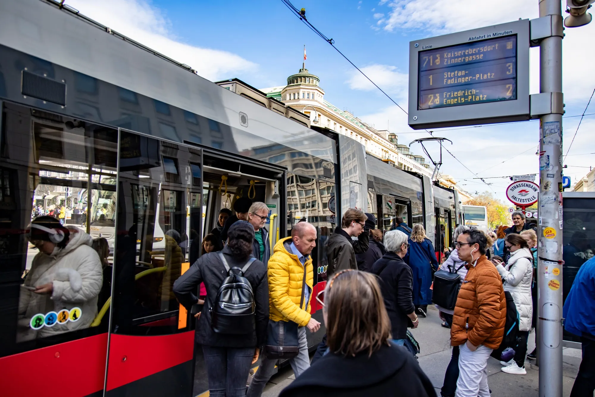 Passengers at a tram stop in Vienna.