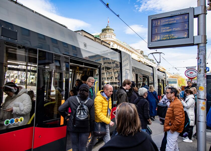 Passengers at a tram stop in Vienna