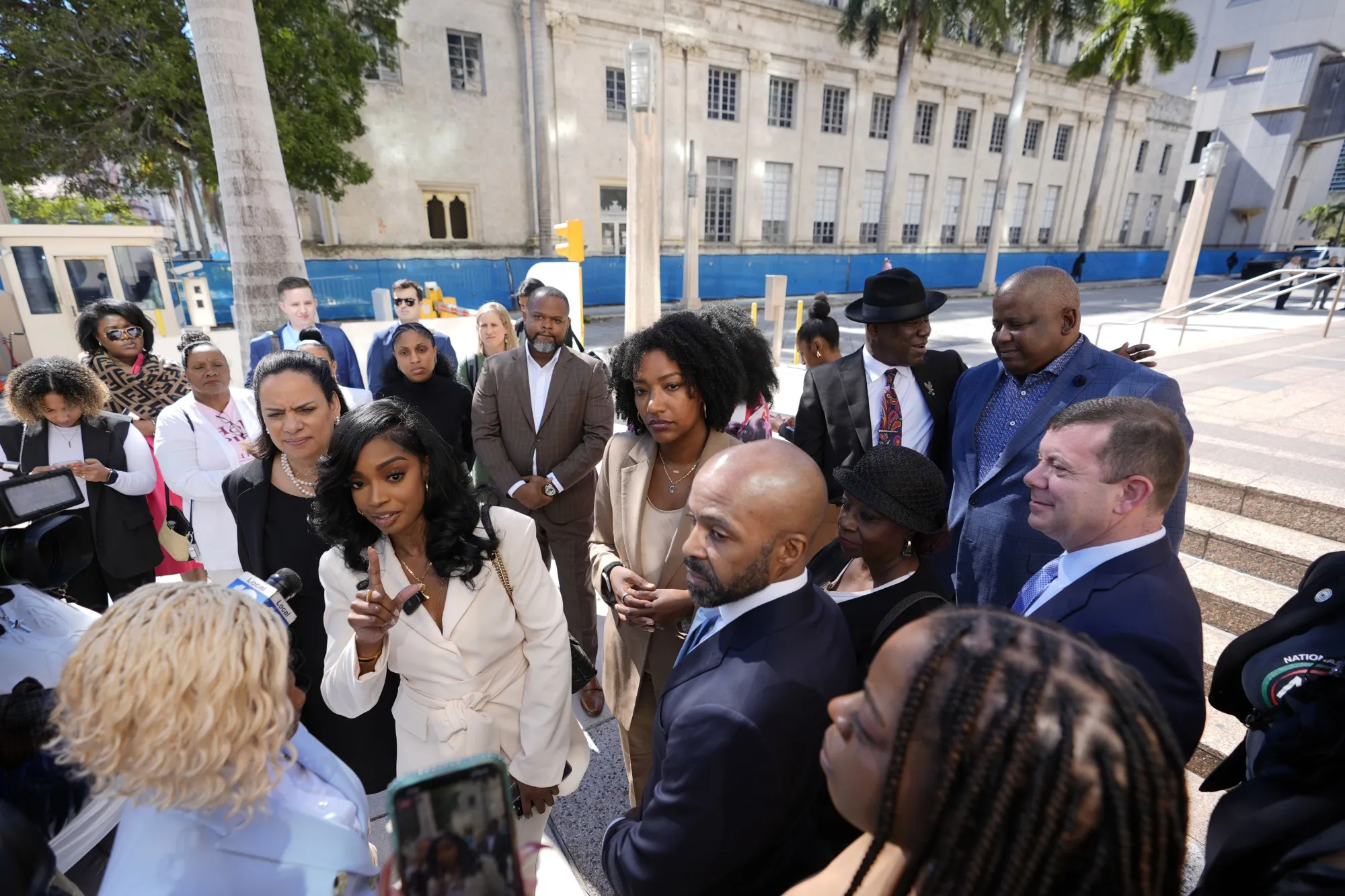 Arian Simone, center left, and Ayana Parsons, center right, co-founders and CEOs of The Fearless Fund, speak to journalists outside federal court in Miami, on Jan. 31.