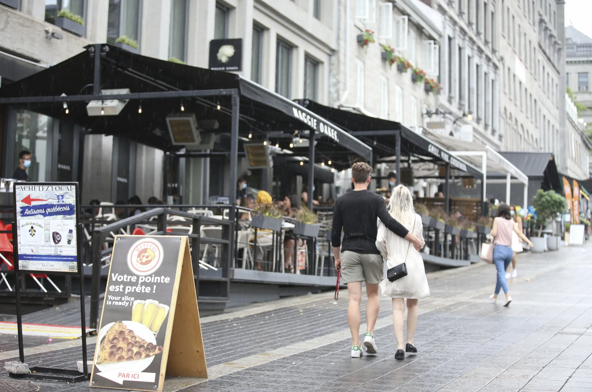 People walk past a reopened&nbsp;outdoor restaurant in Montreal, Canada, in early June. The city endured months under curfew this year to curb a wave of Covid-19 cases.&nbsp;&nbsp;