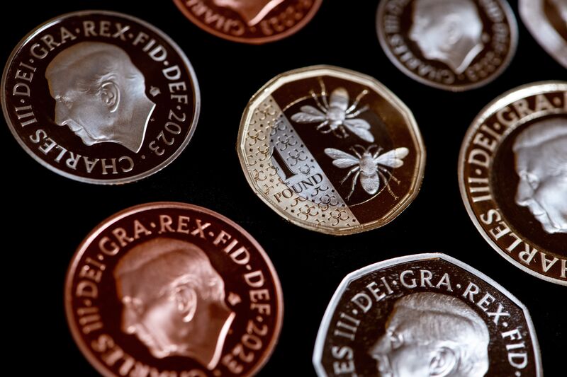 The reverse face of a one-pound coin, featuring a design of bees, displayed by the Royal Mint in London, UK.