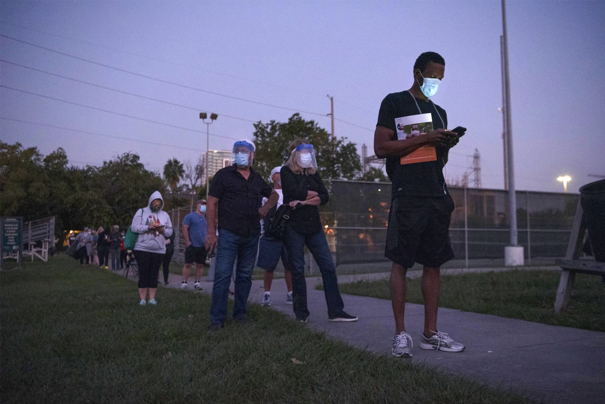 Voters wait in line outside an early-voting polling location in Houston for the 2020 presidential election.