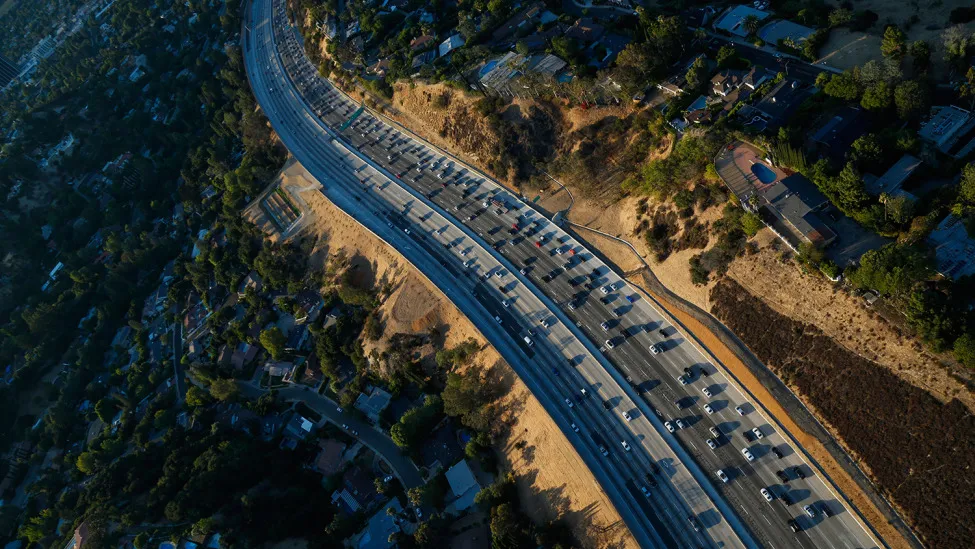 Cars sit in rush hour traffic on the 405 Freeway through the Sepulveda pass in this aerial photograph taken over Los Angeles, California, U.S., on Friday, July 10, 2015.
