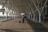 A pedestrian crosses a road at Indira Gandhi International Airport in New Delhi on April 29.