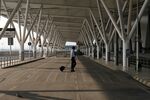 A pedestrian crosses a road at Indira Gandhi International Airport in New Delhi on April 29.