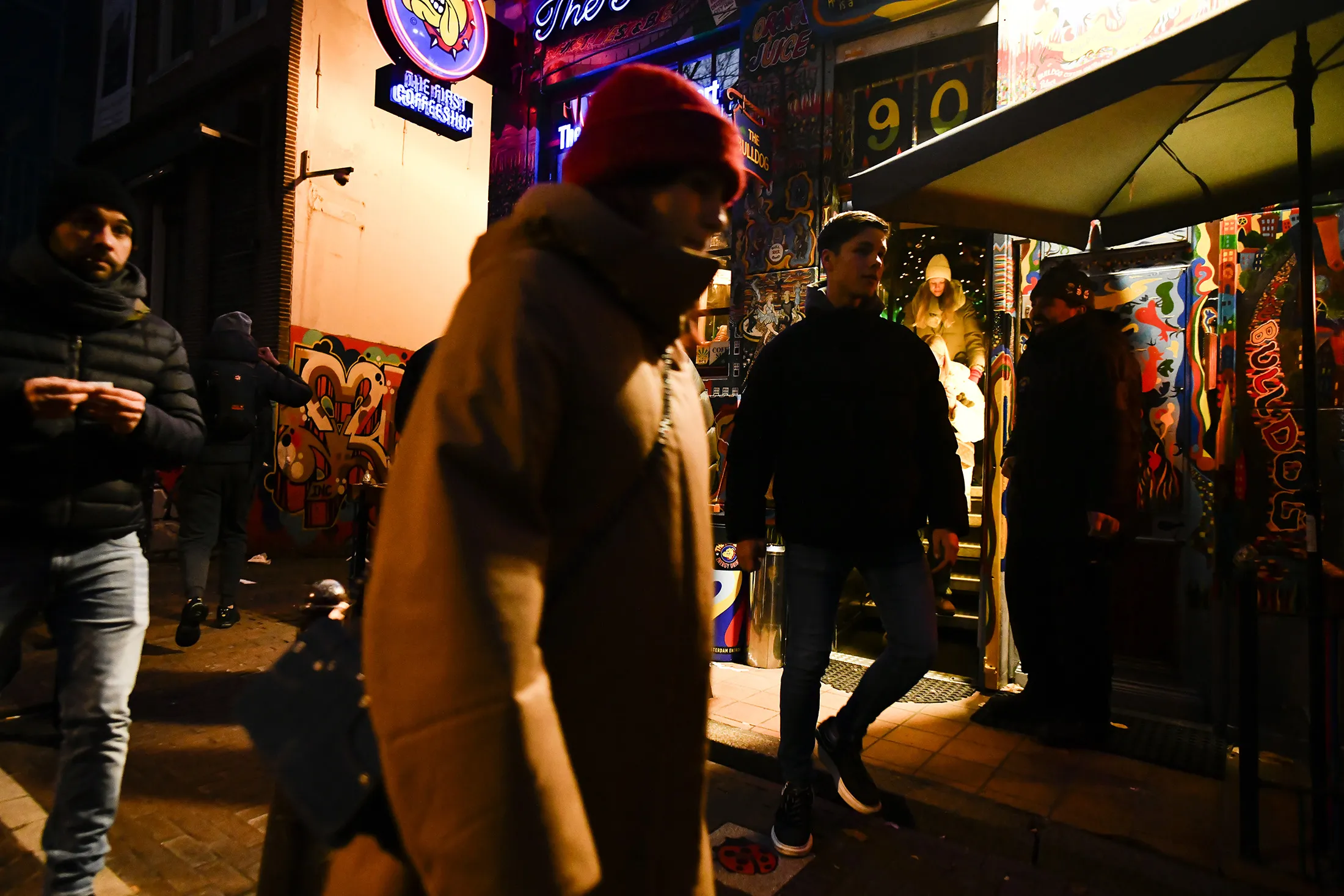 Pedestrians gather near a coffeeshop in the Red Light District of Amsterdam on Dec. 10, 2022.
