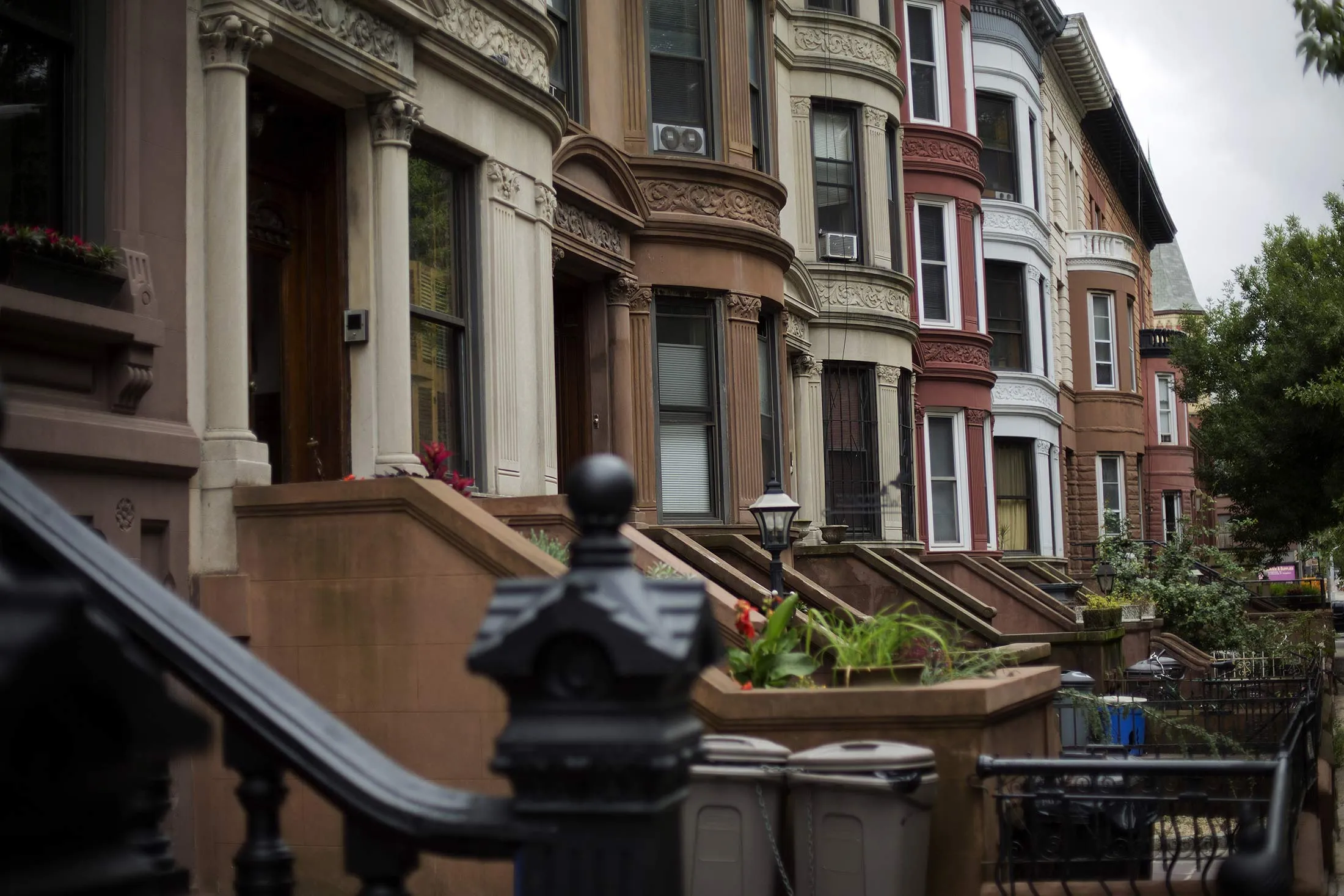 Brownstone buildings line a street of the Bedford-Stuyvesant neighborhood in the Brooklyn borough of New York, U.S.