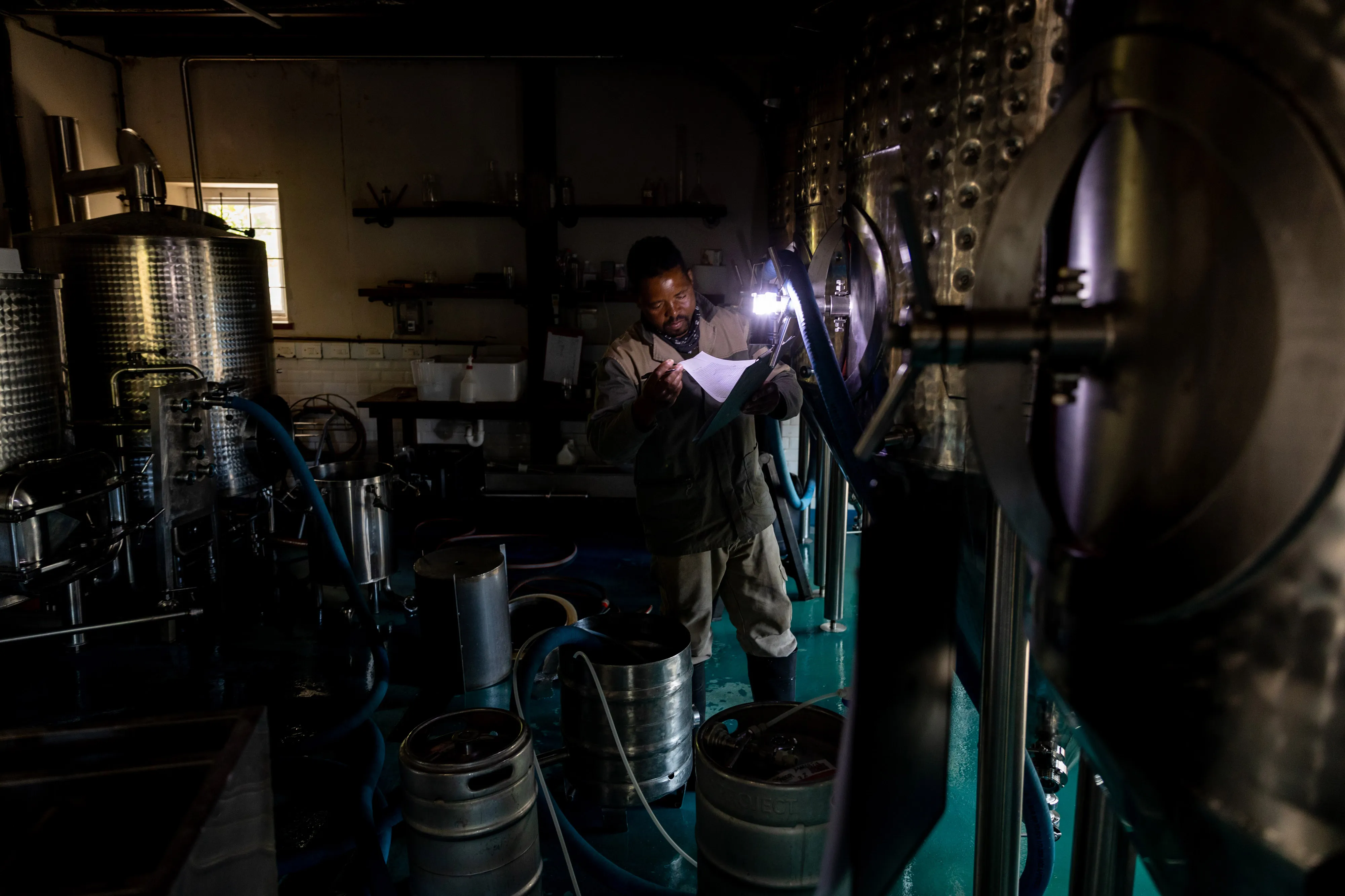 An employee makes notes by torchlight in&nbsp;Cape Town, South Africa in April 2022.&nbsp;