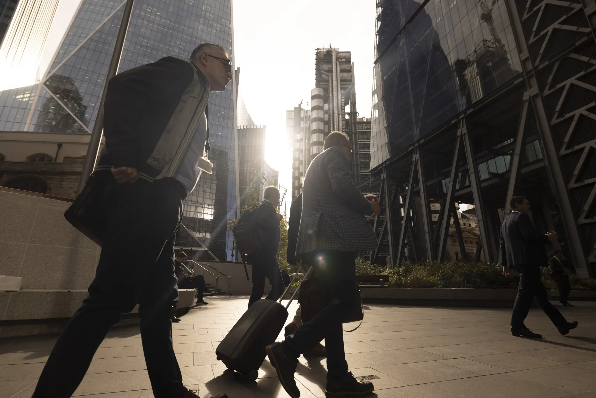 City workers pass skyscrapers in the City of London.