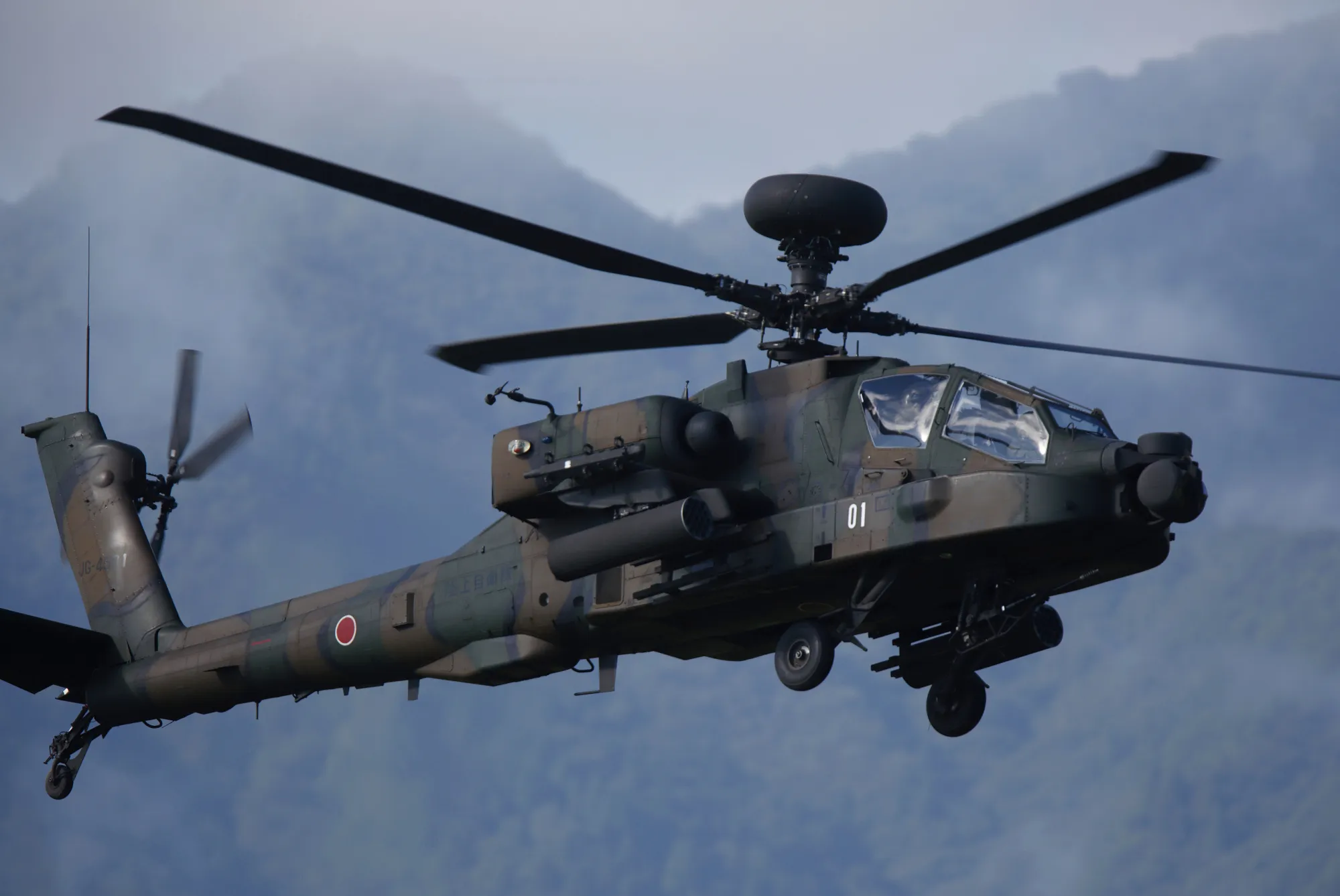 A Japan Ground Self-Defense Force (JGSDF) AH-64D Apache Longbow attack helicopter flies during a live fire exercise at the foot of Mount Fuji in the Hataoka district of the East Fuji Maneuver Area in Gotemba, Shizuoka Prefecture, Japan, on Thursday, Aug. 25, 2016. In a further shift in Japan's pacifist postwar security policy, the military will begin training to carry out new missions overseas.