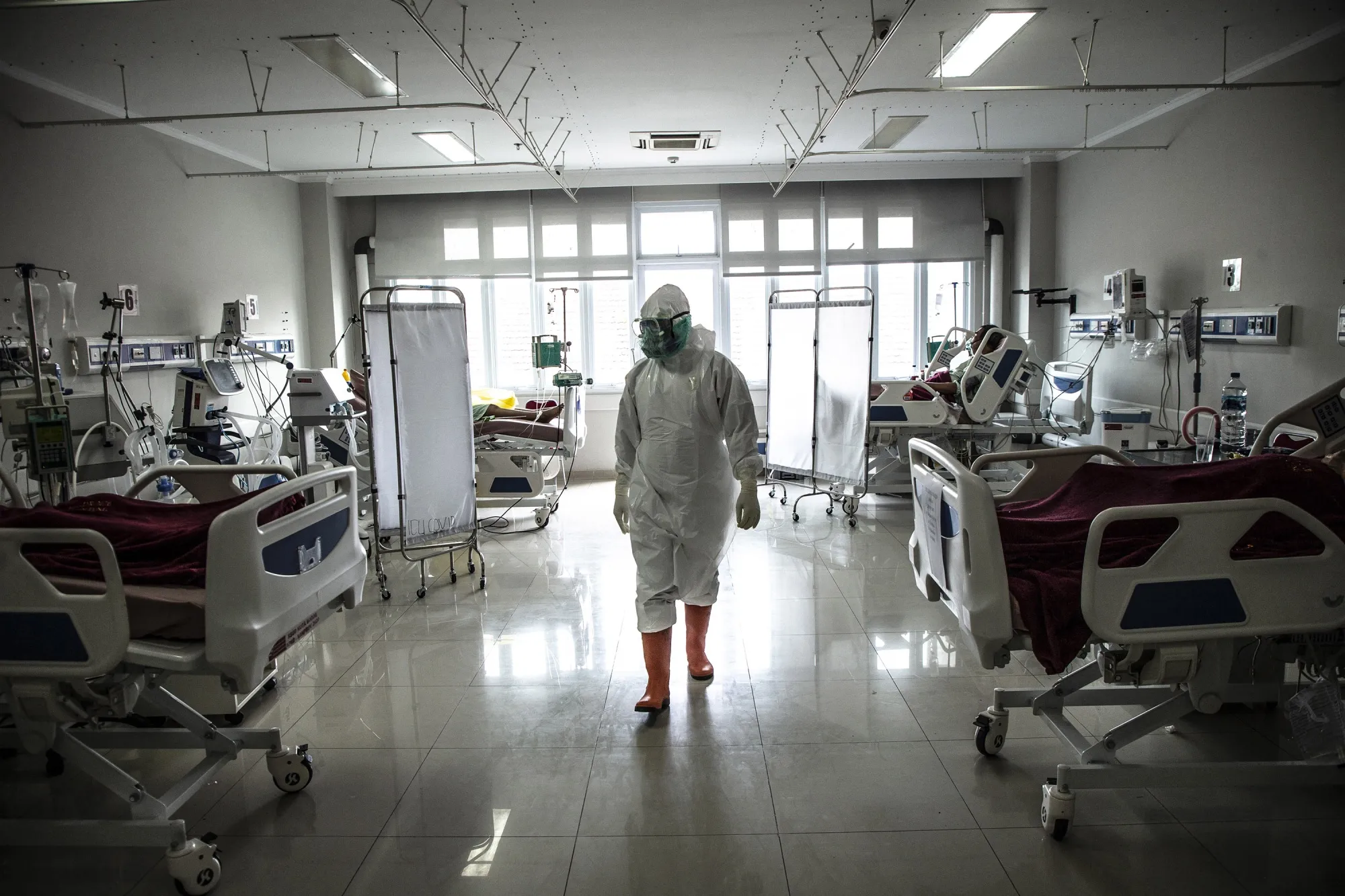 A medical staff member checks on Covid-19 patients in an ICU ward at a hospital in Bogor, Indonesia.