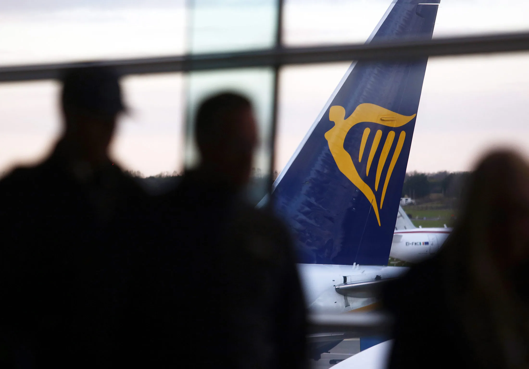 Passengers queue to board a Ryanair Holdings Plc aircraft at Dublin Airport.
