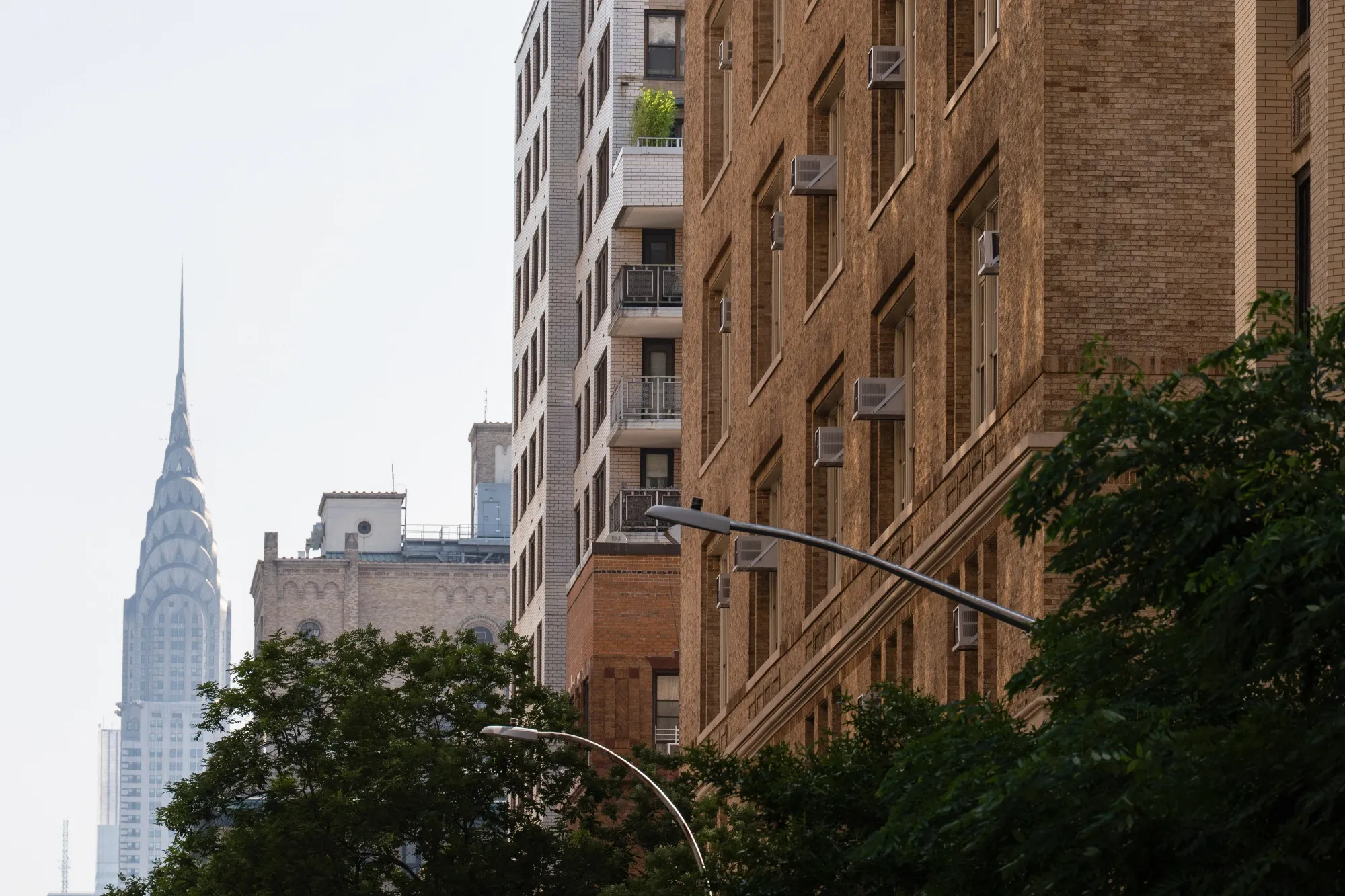 Air conditioning units installed in windows at an apartment building in New York.