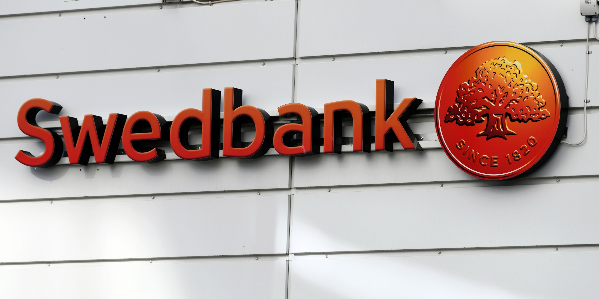 A sign sits on the exterior of the Swedbank AB headquarters in Sundbyberg, Sweden