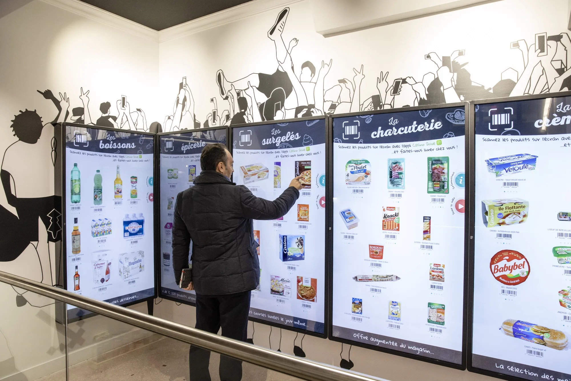 A customer uses touch screen panels to select products at the 'Picking Wall' inside a supermarket, operated by Casino Guichard Perrachon SA, in Paris, France,
