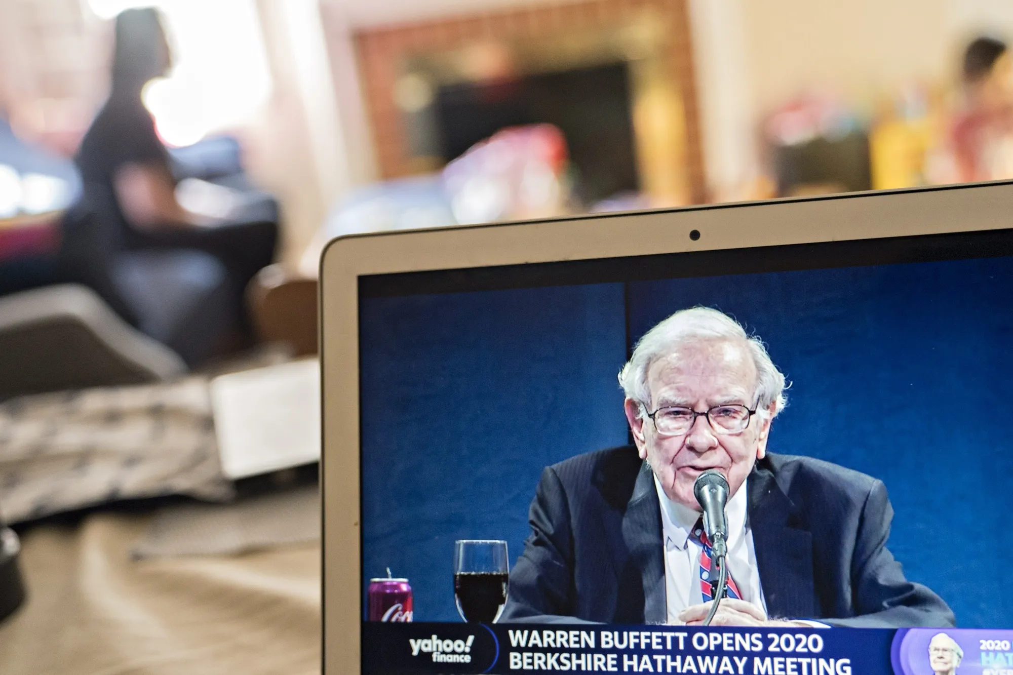 Warren Buffett speaks during the virtual Berkshire Hathaway annual shareholders meeting on a laptop computer.