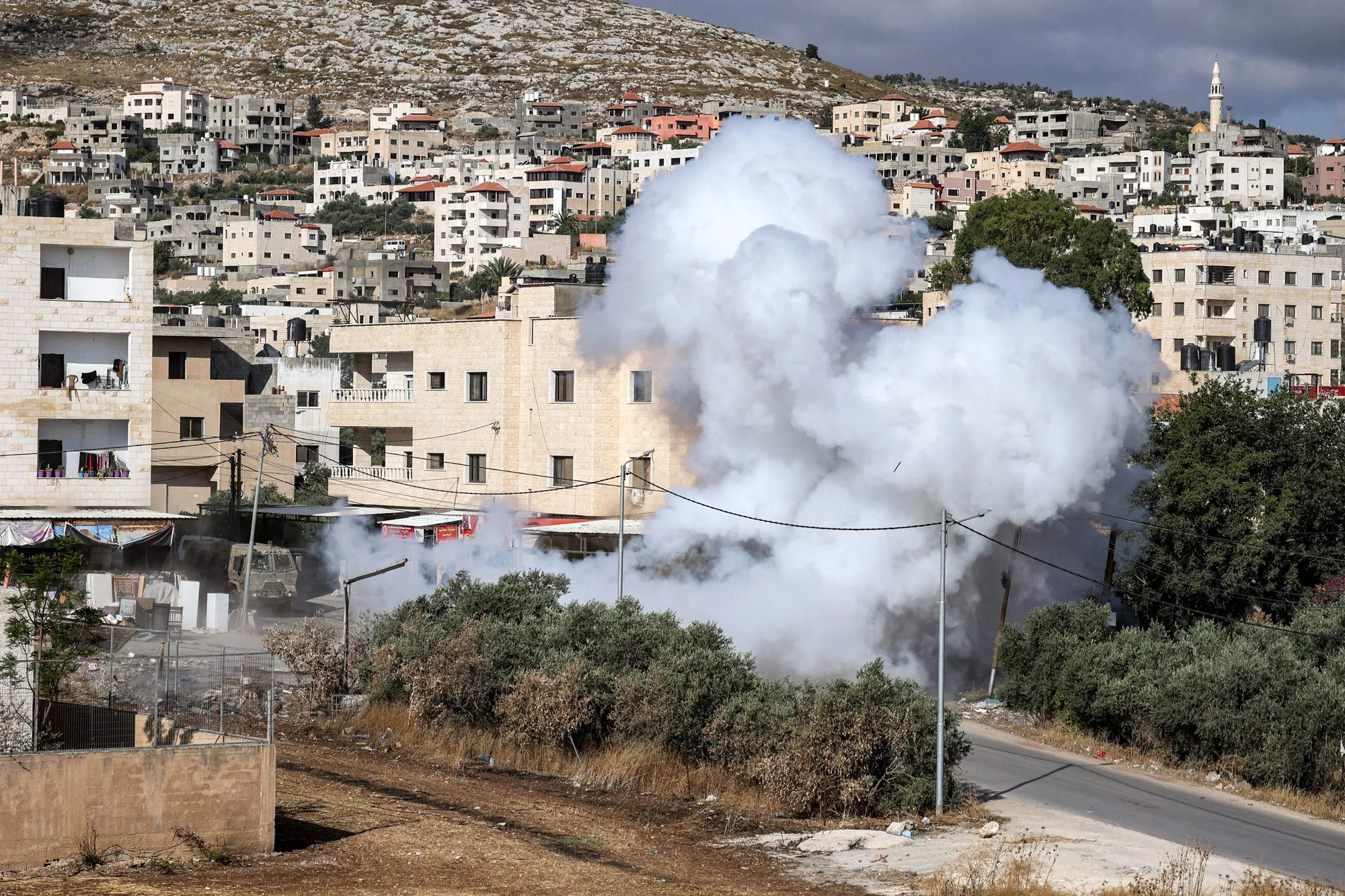 Smoke rises from the site of an Israeli raid in Jenin, West Bank, on June 19.