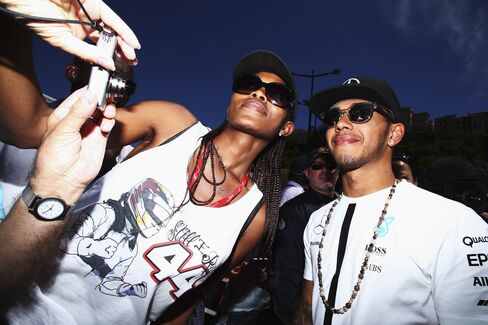 Star driver Lewis Hamilton of Great Britain and Mercedes GP signs autographs for fans during previews to the Monaco Formula One Grand Prix last year. He was the Formula 1 World Champion in 2008, 2014, and 2015.