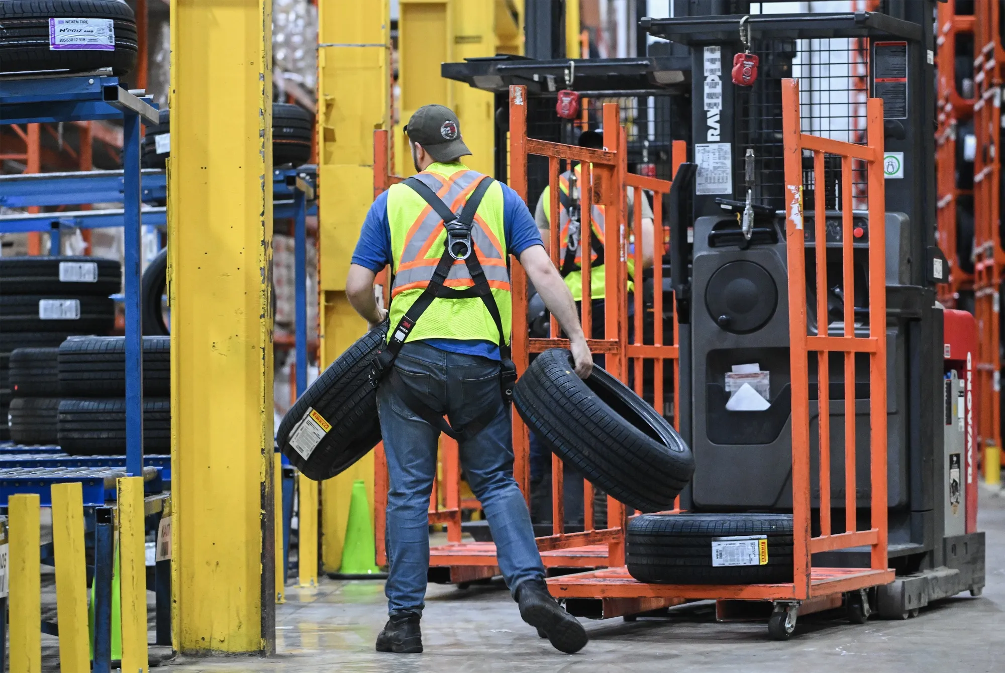 A worker unloads tires at a distribution center in Montreal.