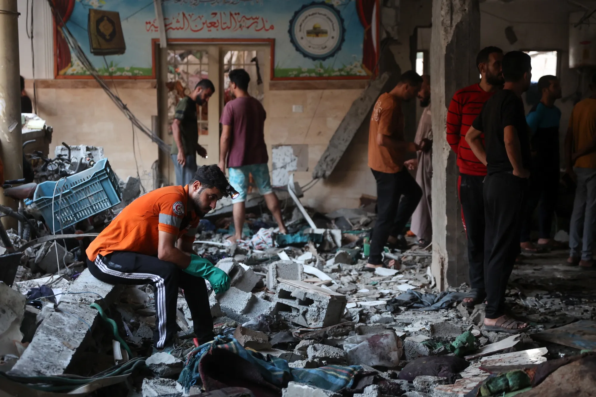 People check the damage inside a school used as a temporary shelter for displaced residents in Gaza City on Aug. 10.