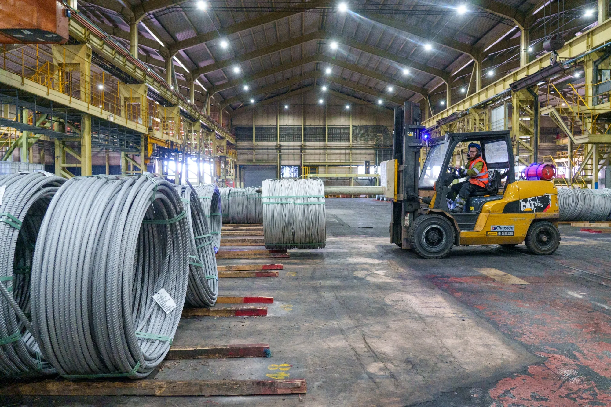 A forklift moves stainless steel coils at a factory in Sheffield.