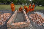 Buddhist monks oversee the making of cremation furnaces at Wat Rat Samakee temple in Uthai Sawan, Thailand, on Oct. 10.
