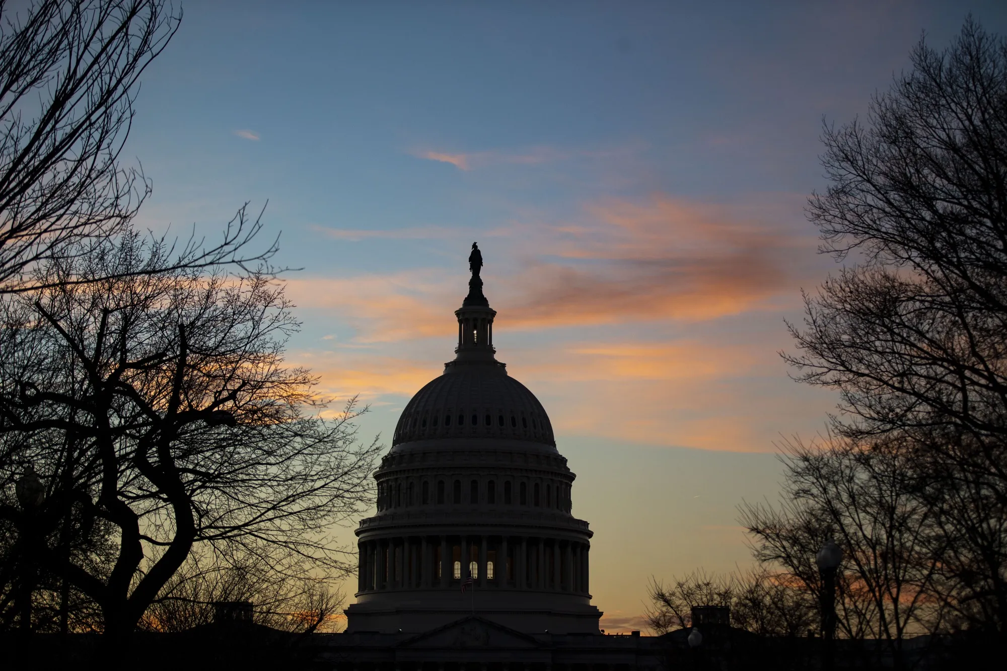 The U.S. Capitol building stands at sunset in Washington, D.C.
