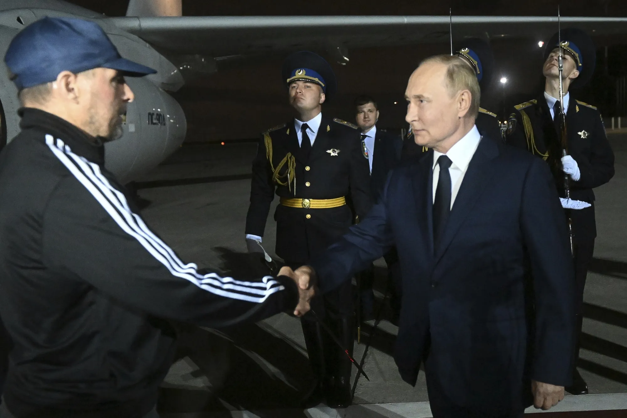 Russian President Vladimir Putin, right, greets Vadim Krasikov near Moscow yesterday, in a photo released by Russian state media.
