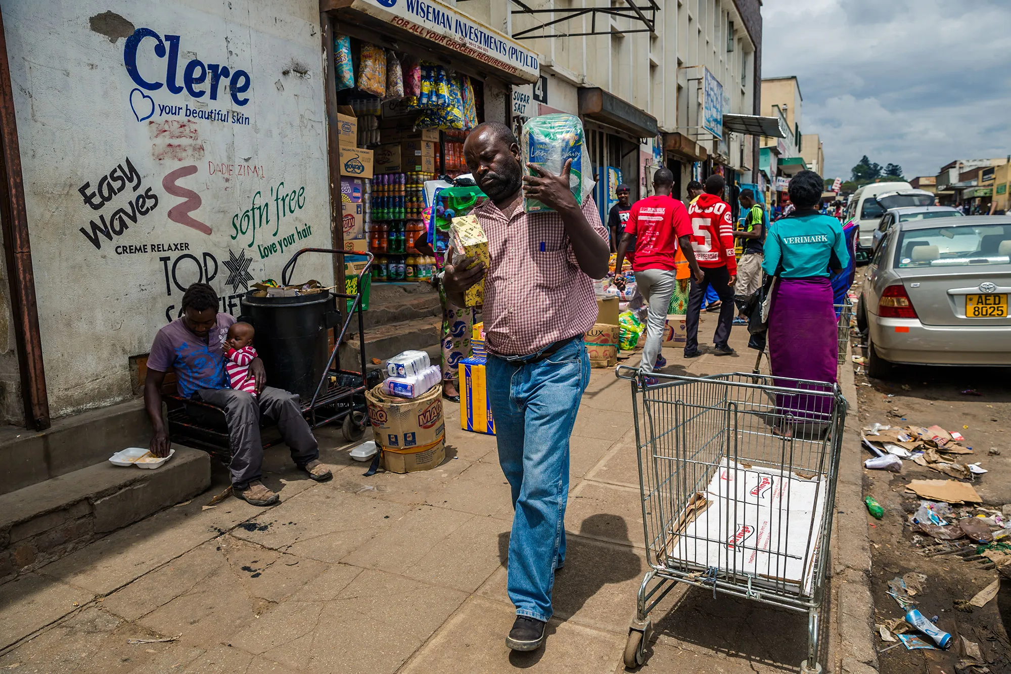 Shoppers walk by&nbsp;markets&nbsp;in the Zimbabwean capital of Harare.