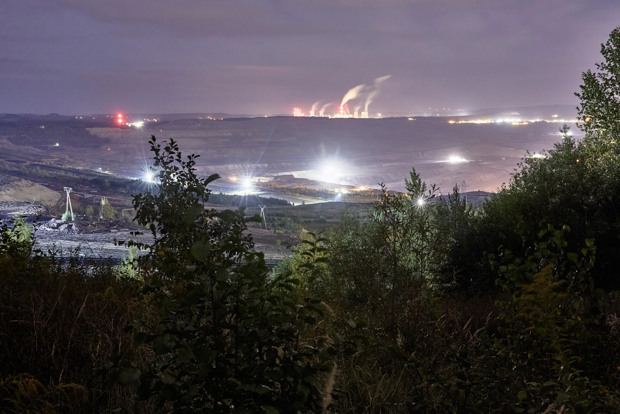 Lights illuminate the&nbsp;open pit lignite mine near the&nbsp;Turow power plant in Bogatynia, Poland.