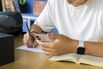 Student Using Smartphone and Smartwatch for AI-Assisted