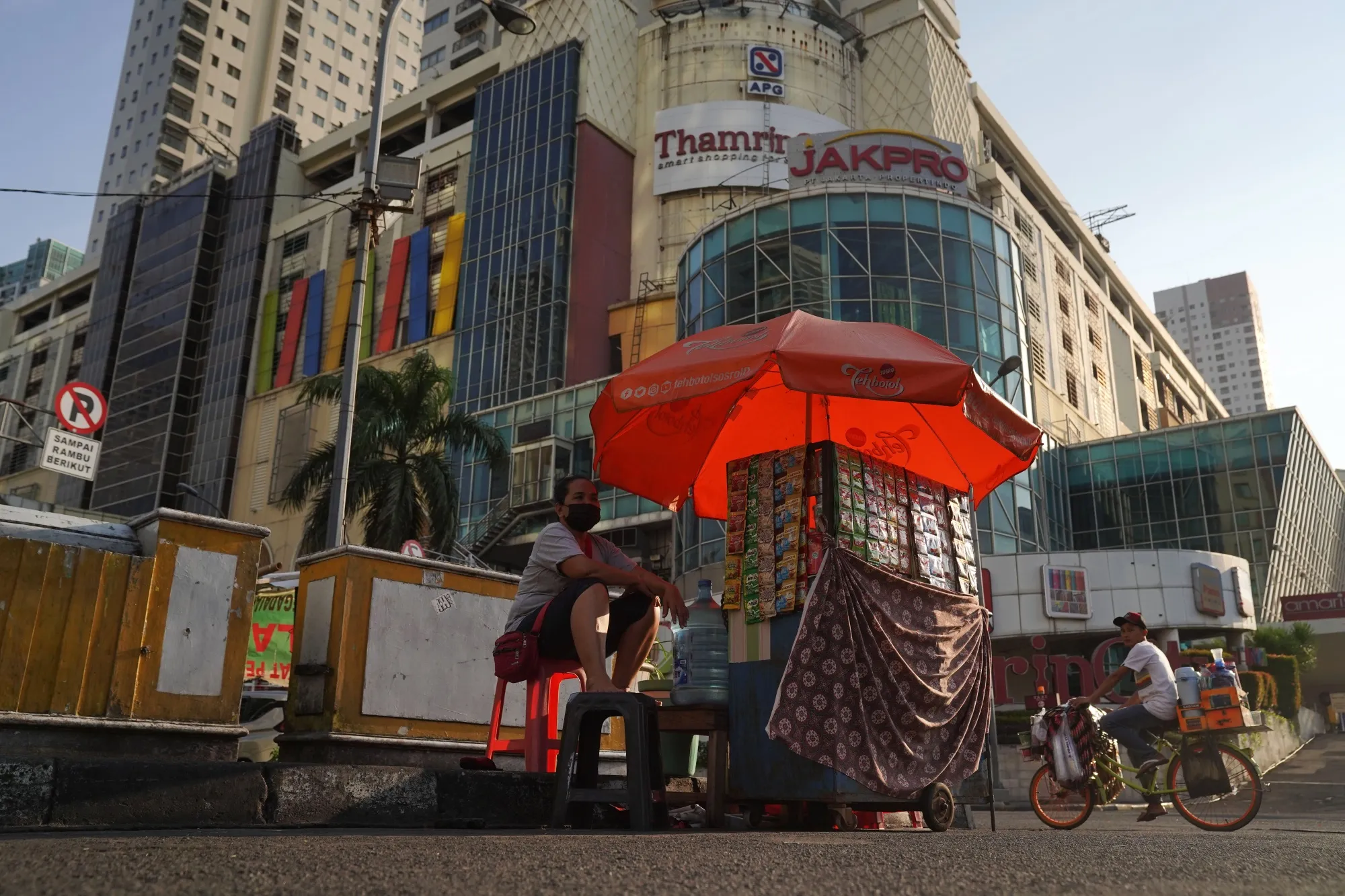 A street vendor is set up on a near-empty road in Jakarta, on July 28.