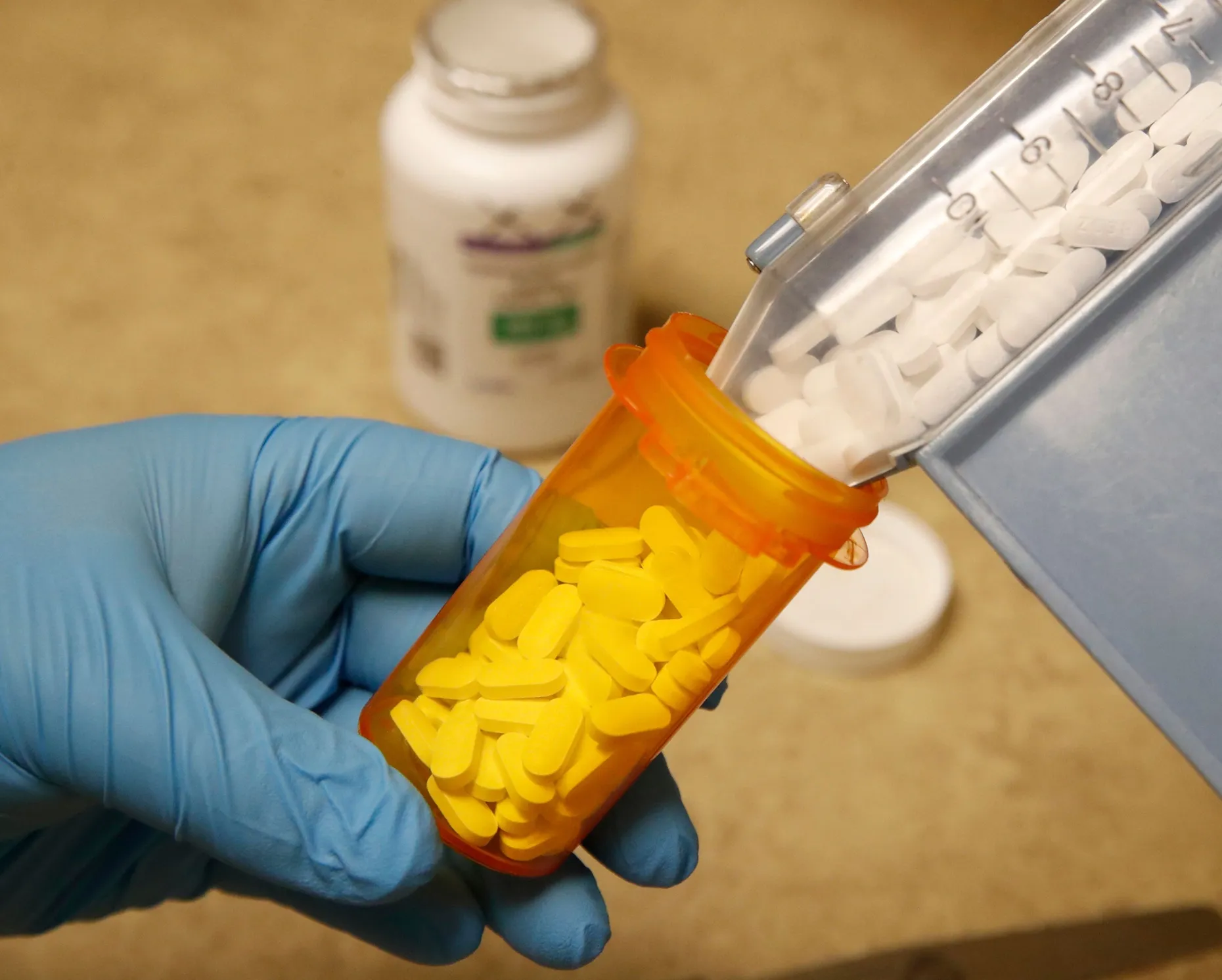 A pharmacy tech puts pills of Hydroxychloroquine in a bottle in Provo, Utah.